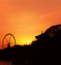 Silhouette of Ferris Wheel and Temple agaisnt the Sunset