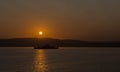 Silhouette Ferry Under Setting Sun Royalty Free Stock Photo