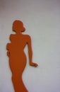 Silhouette. figure or silhouette of a sinuous red or orange woman on a white and gray background.