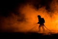 Silhouette of firefighter battling blaze Royalty Free Stock Photo