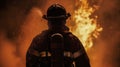 Silhouette of firefighter in helmet and uniform against background of red flames and clouds of smoke. Dangerous work of lifeguard