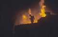 Silhouette of fireman in front of blaze, Beverly Hills, California