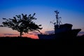 silhouette of a fisherboat in sunset