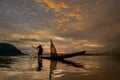 Silhouette fisherman of Bangpra Lake in action when fishing. Royalty Free Stock Photo