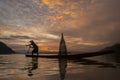 Silhouette fisherman of Bangpra Lake in action when fishing. Royalty Free Stock Photo