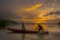 Silhouette fisherman of Bangpra Lake in action when fishing. Royalty Free Stock Photo