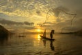 Silhouette fisherman of Bangpra Lake in action when fishing. Royalty Free Stock Photo