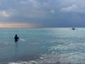 Silhouette of the fisherman in blue sea, man in water, fisherman with net