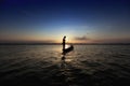 silhouette fisherman and boat in river on during sunset,Thailand Royalty Free Stock Photo