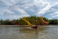 Silhouette of fisherman casting fishing net into the river Royalty Free Stock Photo