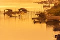 Silhouette fisherman casting the net catch fish during standing on wooden boat on sunset time Royalty Free Stock Photo