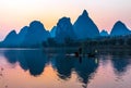 Silhouette of Fisherman with Cormorant Bird on Boat China River