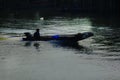 Silhouettes of boats fishing in running water. Royalty Free Stock Photo