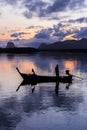 Silhouette fisherman in fishing boat on sea