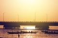 Silhouette of fisherman fishing near Suramadu bridge