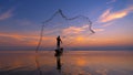 Silhouette Fisherman fishing nets on the boat. Silhouette of fishermen using coop-like trap catching fish in lake with beautiful s Royalty Free Stock Photo