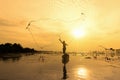 Silhouette fisherman fishing nets on the boat. Thailand, Silhouette of fishermen using nets to catch fish at the lake in the morni Royalty Free Stock Photo