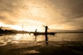 Silhouette Fisherman Fishing by using Net on the boat with sunlight in Thailand, Nature and Culture concept Royalty Free Stock Photo