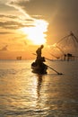 Silhouette of fisherman on his boat at sunrise in the morning Royalty Free Stock Photo