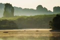 Silhouette Fisherman on misty lake Royalty Free Stock Photo