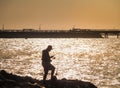 Silhouette of fisherman with sparkling sea water Royalty Free Stock Photo