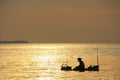 Silhouette of fisherman at sunrise, Gulf of Thailand, Cambodia