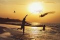 Silhouette of a fisherman at sunset throwing a fishing net