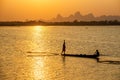 A silhouette fisherman throw a net to catch a fish in a river in Royalty Free Stock Photo