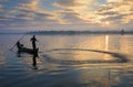 The silhouette of Fisherman throwing net in the early morning near U Bein Bridge, , Taungthaman Lake near Amarapura, Myanma