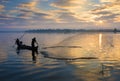 The silhouette of Fisherman throwing net in the early morning near U Bein Bridge, , Taungthaman Lake near Amarapura, Myanma