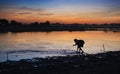 The silhouette of Fisherman throwing net in the early morning near U Bein Bridge, , Taungthaman Lake near Amarapura, Myanma