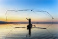 Silhouette of fisherman trowing the nets during sunset Royalty Free Stock Photo
