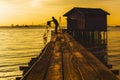 Silhouette of fisherman using net rowing catching fish in chew jetty village.