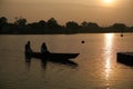 Silhouette fisherman on wooden boat