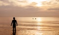 Silhouette of fishermans with sunrise in the background