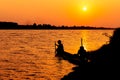 Silhouette of fishermen catch fish in the canal Royalty Free Stock Photo