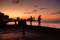 Silhouette of fishermen and the city skyline in Havana