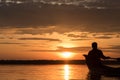 Silhouette of Fishermen driving boat for fishing in sunset time