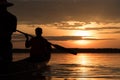 Silhouette of Fishermen driving boat for fishing in sunset time