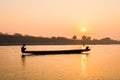 Fishermen in the boat on sunrise background