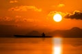 Silhouette of fishermen on the lake with sunset sky Royalty Free Stock Photo