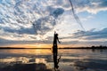 Silhouette of Fishermen throwing net fishing in sunset time at W Royalty Free Stock Photo