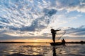 Silhouette of Fishermen throwing net fishing in sunset time at W Royalty Free Stock Photo