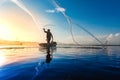 Silhouette of fishermen using coop-like trap catching fish in la Royalty Free Stock Photo
