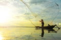 Silhouette of fishermen using coop-like trap catching fish in lake with beautiful scenery of nature morning sunrise. Beautiful sce Royalty Free Stock Photo