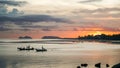 Silhouette of Fishing boat on a calm sea in sunlight. Sunset over the landscape and fishermen\'s boats in Thailand Royalty Free Stock Photo