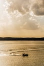 Silhouette of fishing boat on lake - Golden Sunrise / Sunset Royalty Free Stock Photo