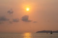 Silhouette of fishing boat and The lighthouse in the sea with eflection of the sun on the sea Royalty Free Stock Photo