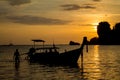 Silhouette of fishing boat and man at sunset on sea beach resort in Thailand, Krabi, Railey and Tonsai Royalty Free Stock Photo