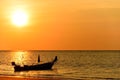 Silhouette of fishing boat on sea beach with sunset background Royalty Free Stock Photo